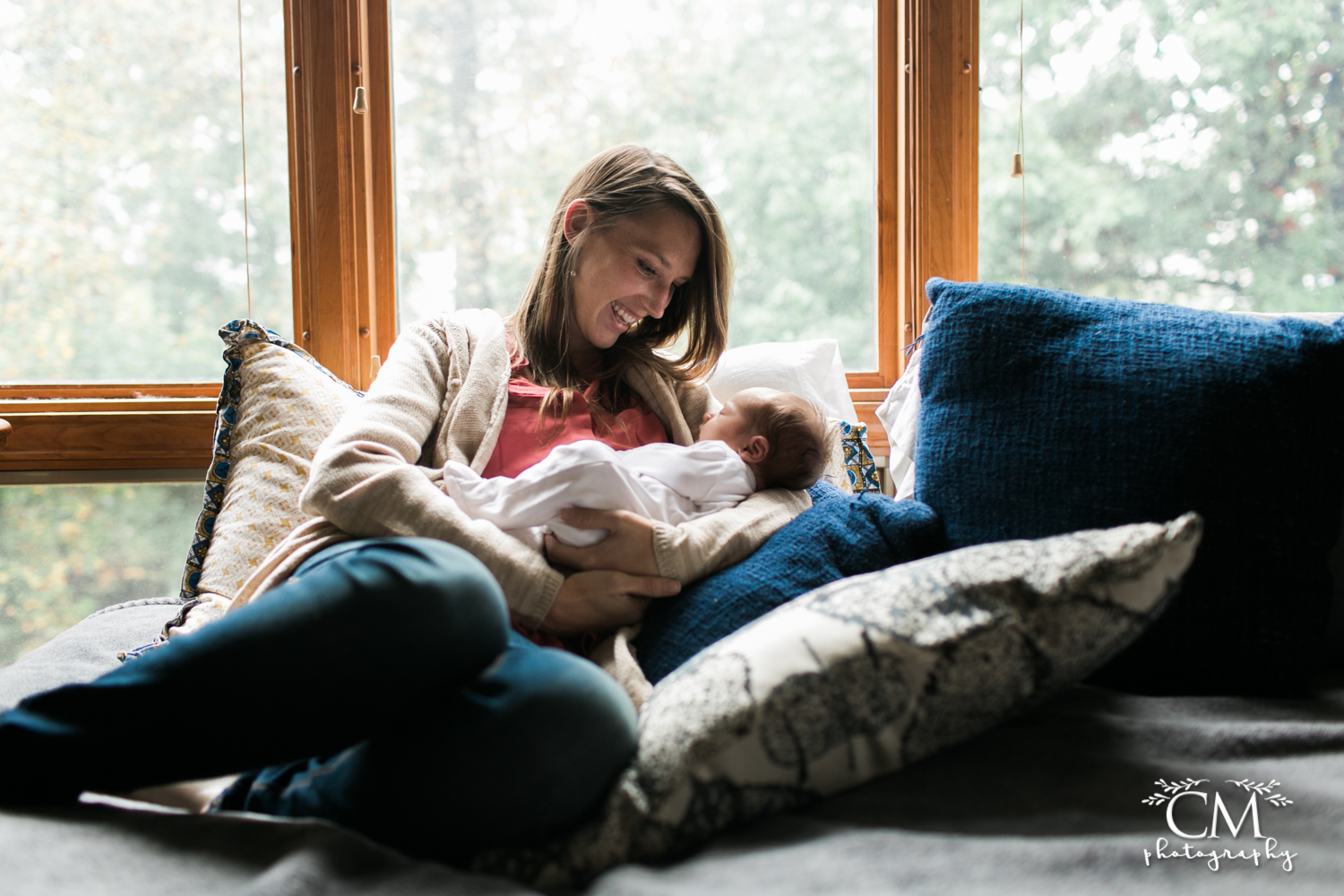 new mom lounging with newborn