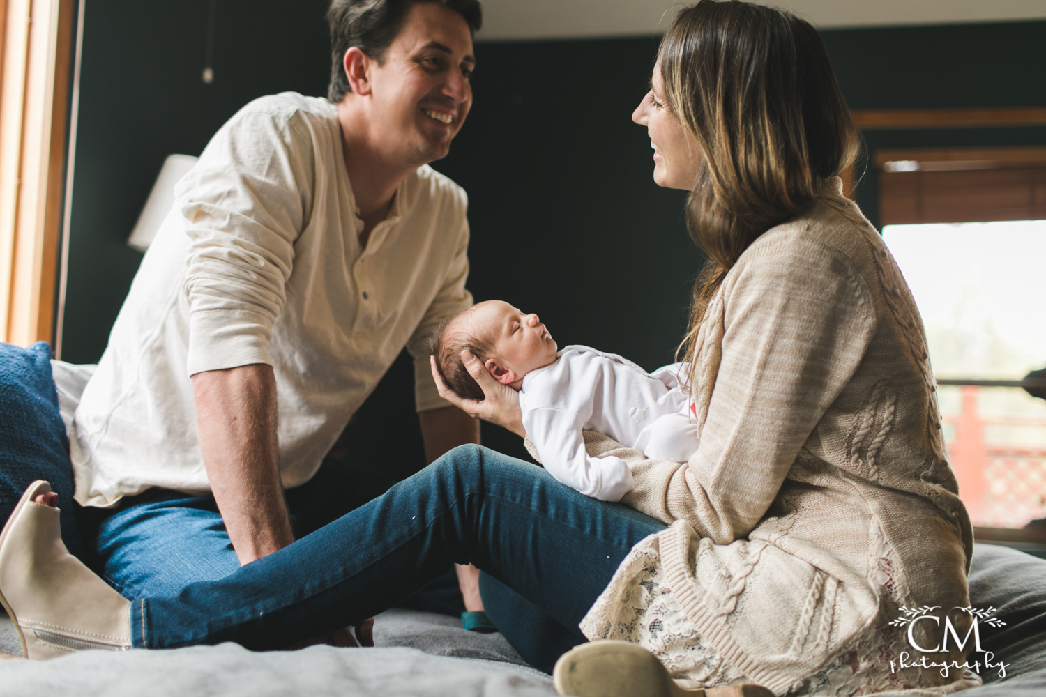 laughing new parents with new baby