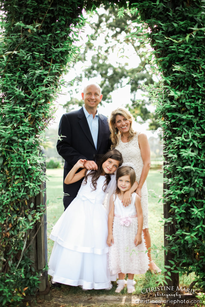 family of four under an ivy arch 
