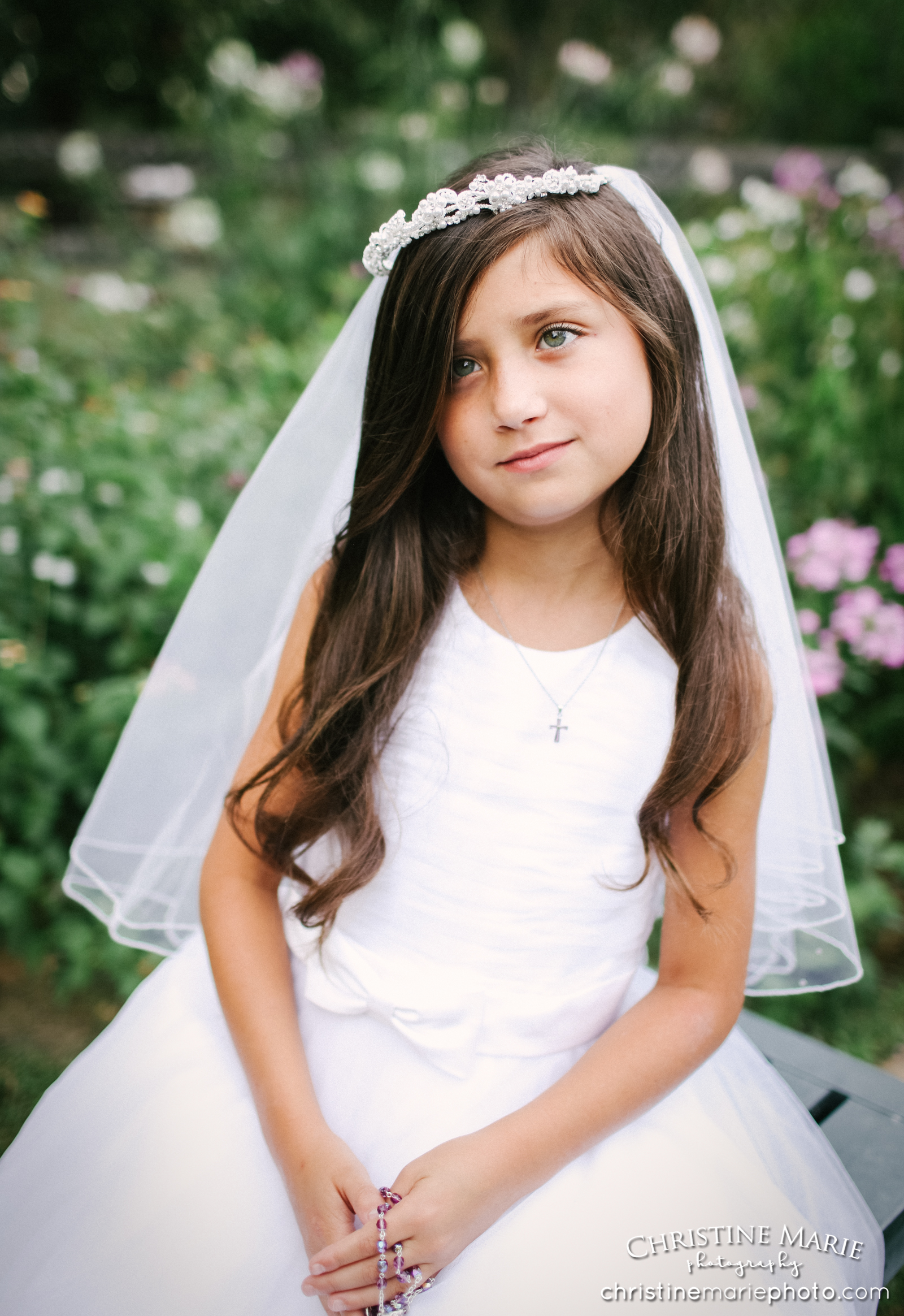 little girl with rosary in first holy communion dress 