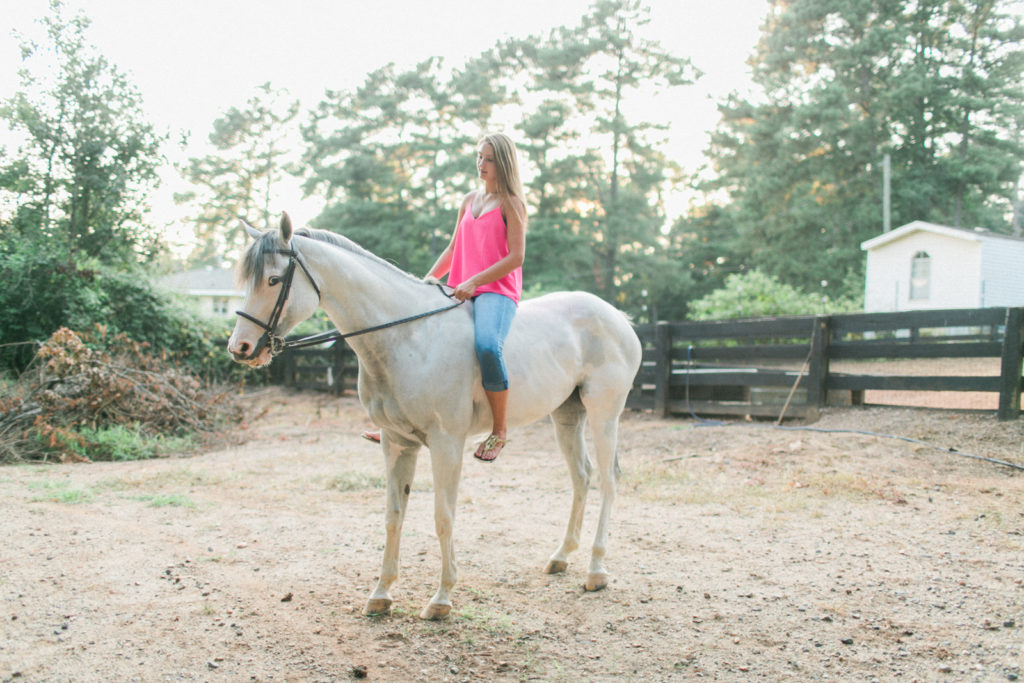 teenage girl riding white horse