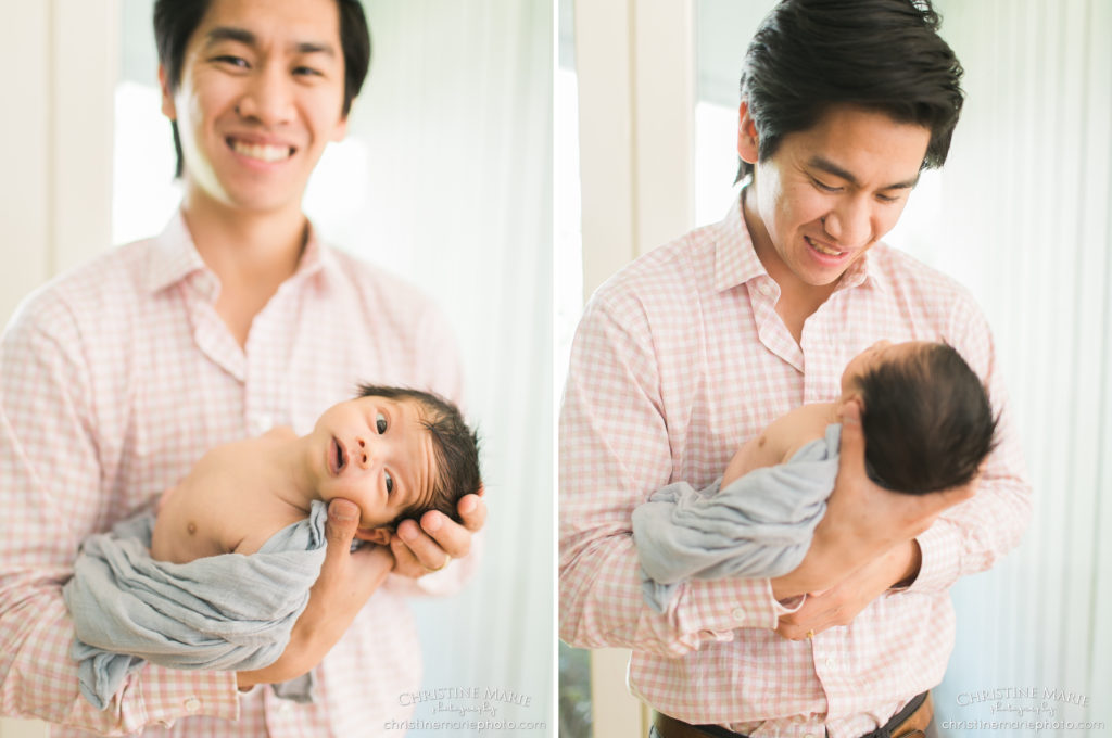 adoring father holding his newborn baby boy