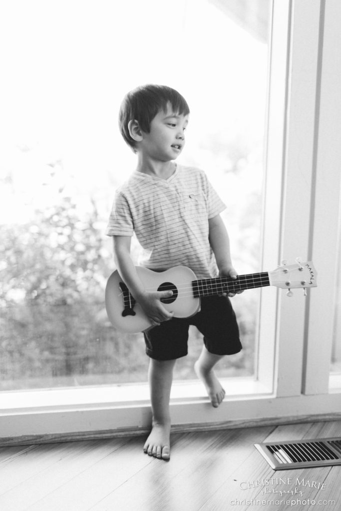 toddler big brother playing guitar 