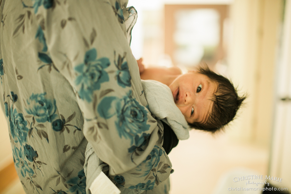 newborn baby head peaking out 