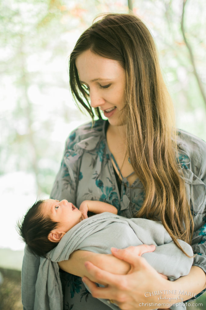 lovely mom admiring newborn baby