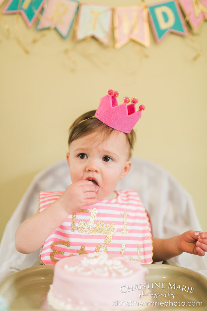 first birthday little queen wearing her crown 