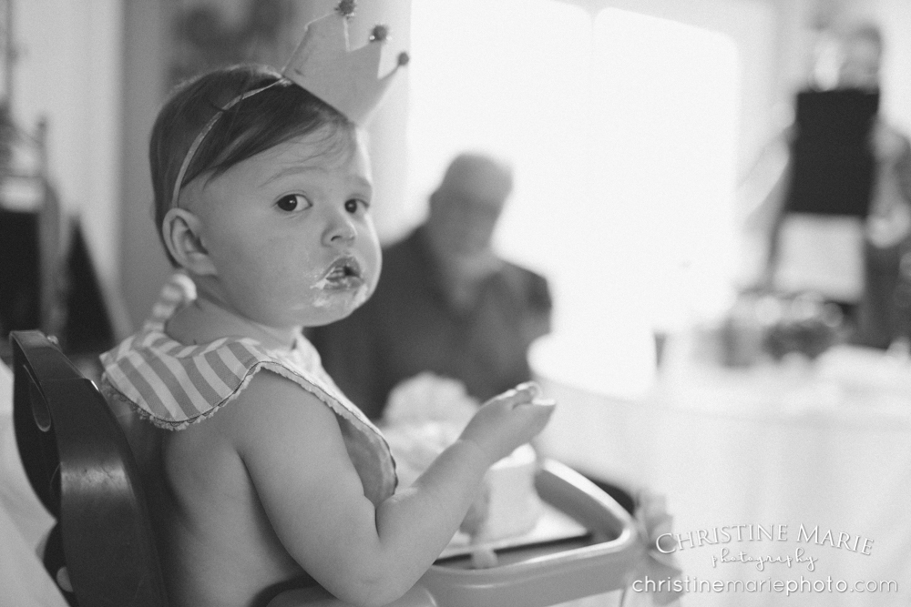 one year old girl stuffing her face with cake 