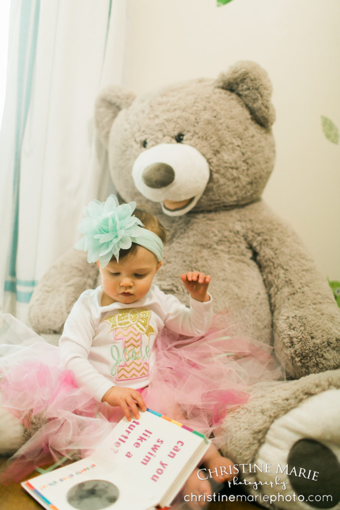 little girl in nursery with giant teddy bear 