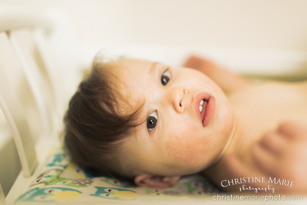 little girl laying on changing table