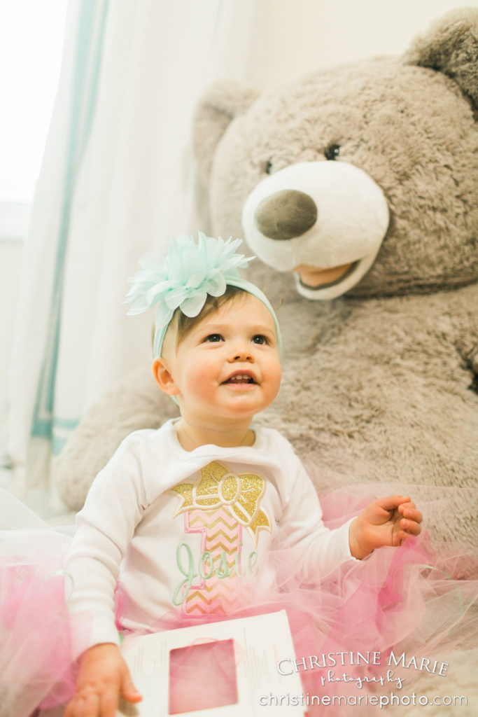 little girl in nursery with giant teddy bear 