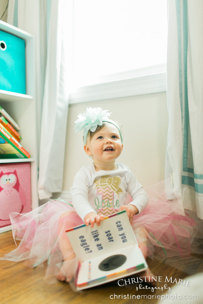 happy baby girl with her flower headband and books