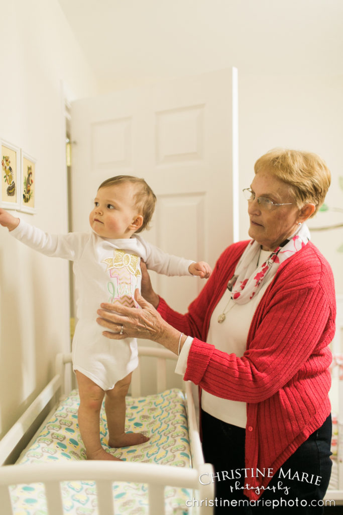 one year old girl getting ready with grandma 