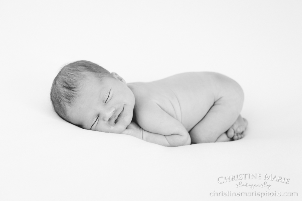 smiling asleep newborn baby black and white