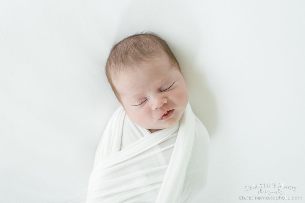 bundled up asleep newborn baby 