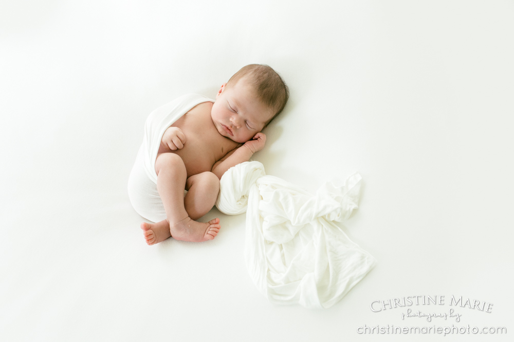 sleepy newborn baby girl in natural light