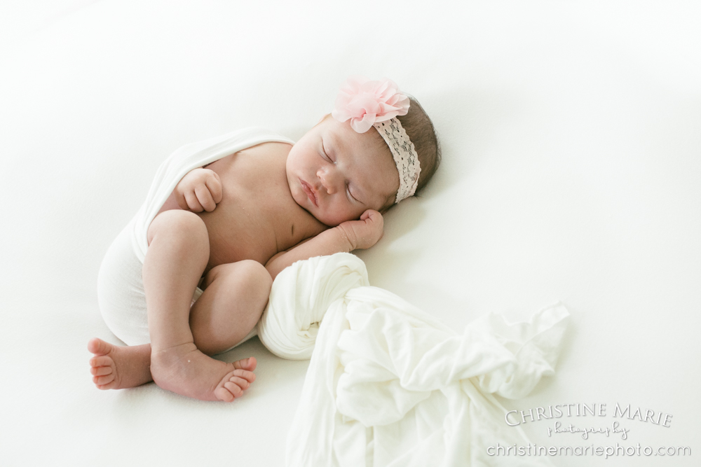 sleeping newborn girl with pink headband