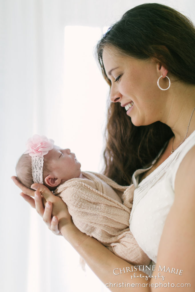 mother and baby profile smiling with back light 