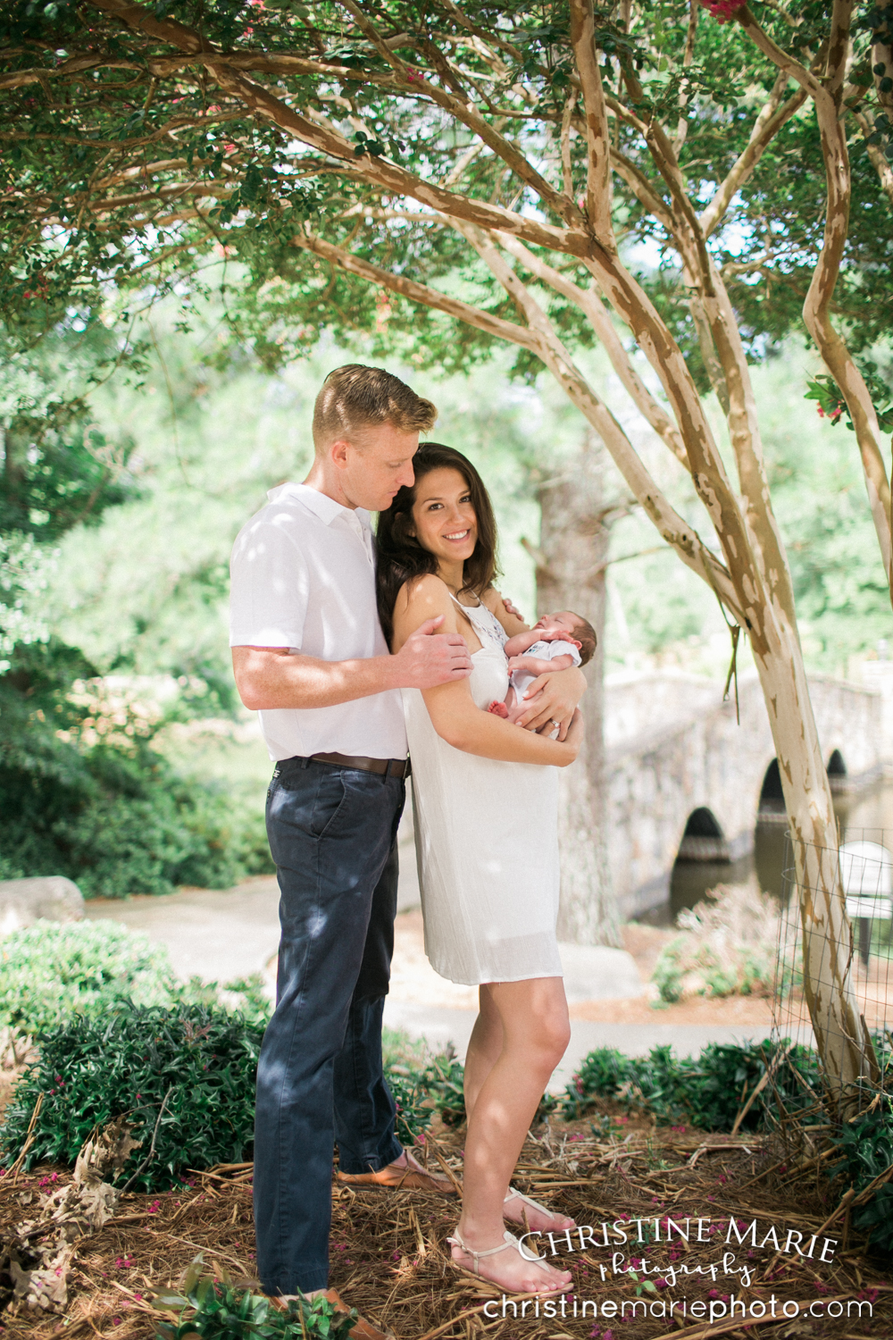 new family of three under a tree