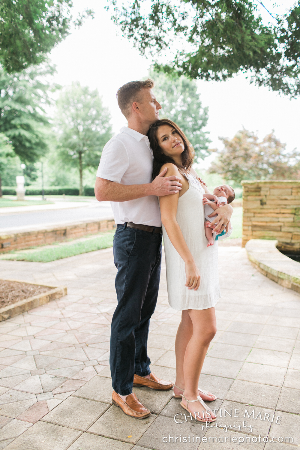 young parents holding new baby 