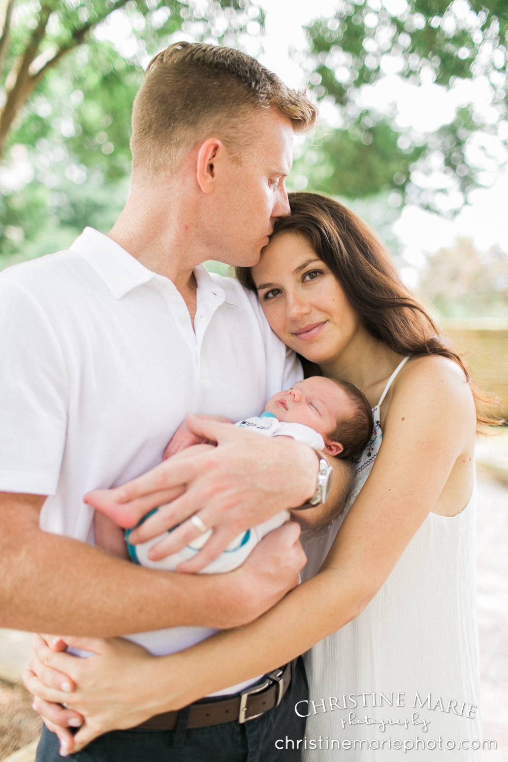 luminous portrait of new parents with baby
