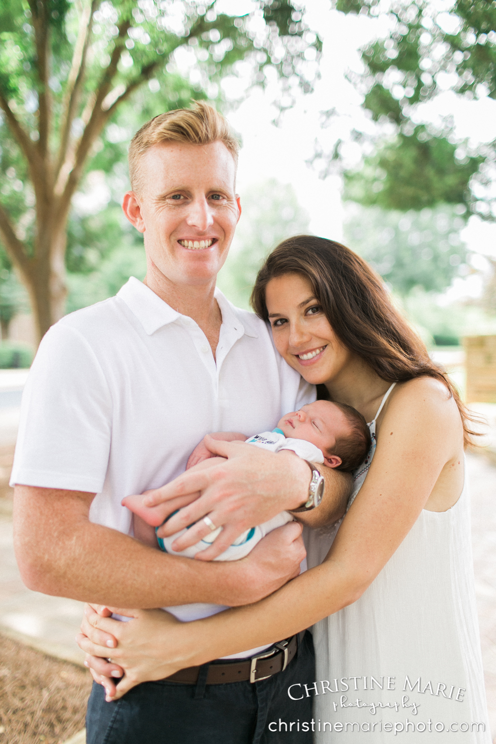 bright happy portrait of new parents and baby