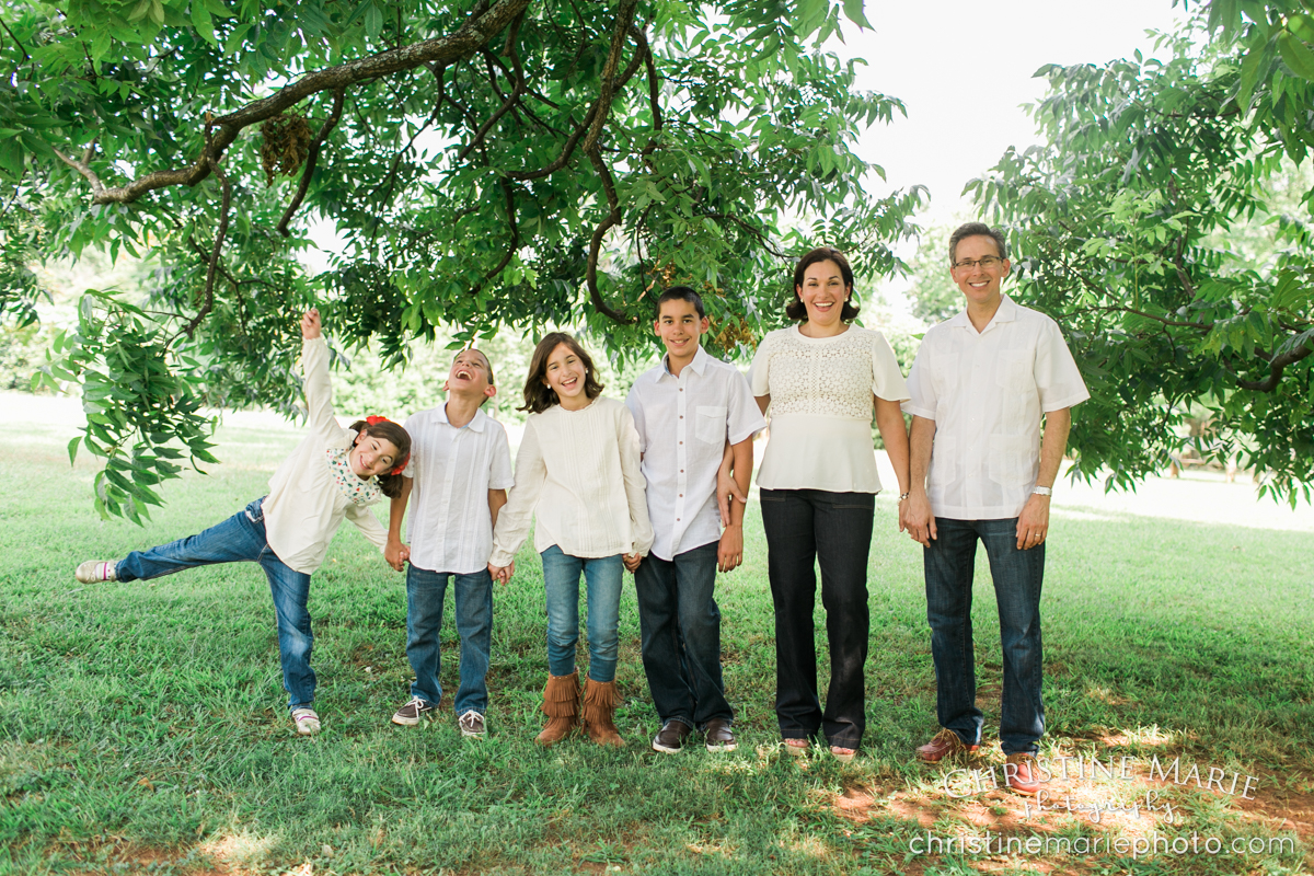 large family laughing under a tree roswell, ga