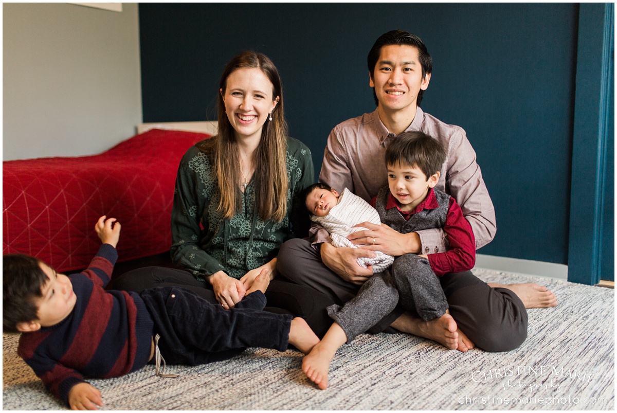 happy family with 3 boys in nursery