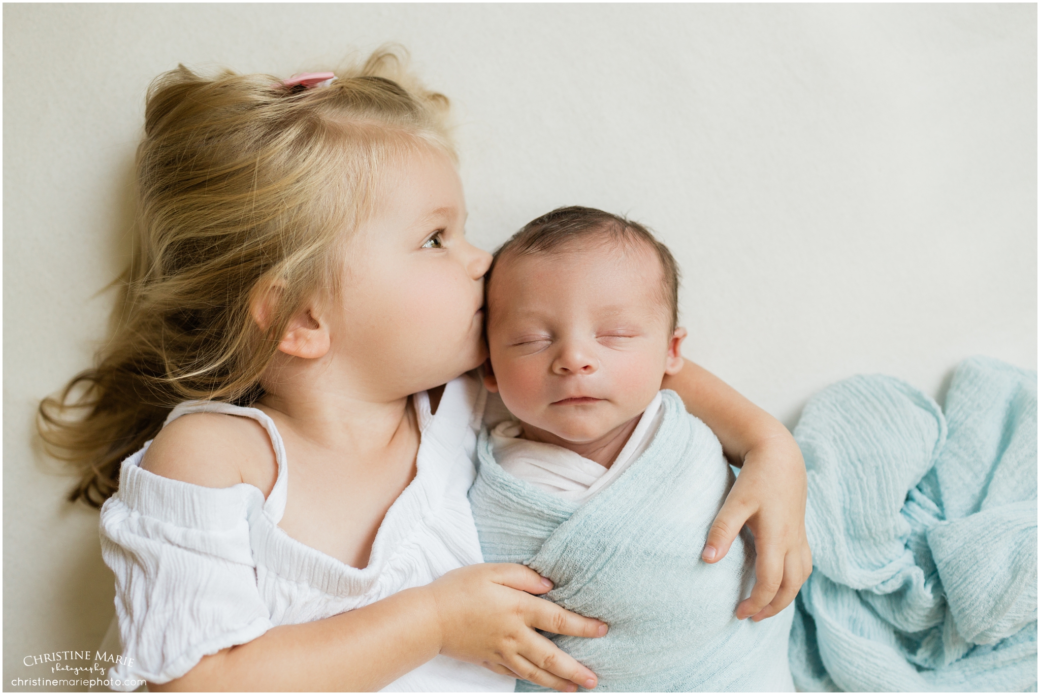 big sister kissing baby brother, christine marie photography