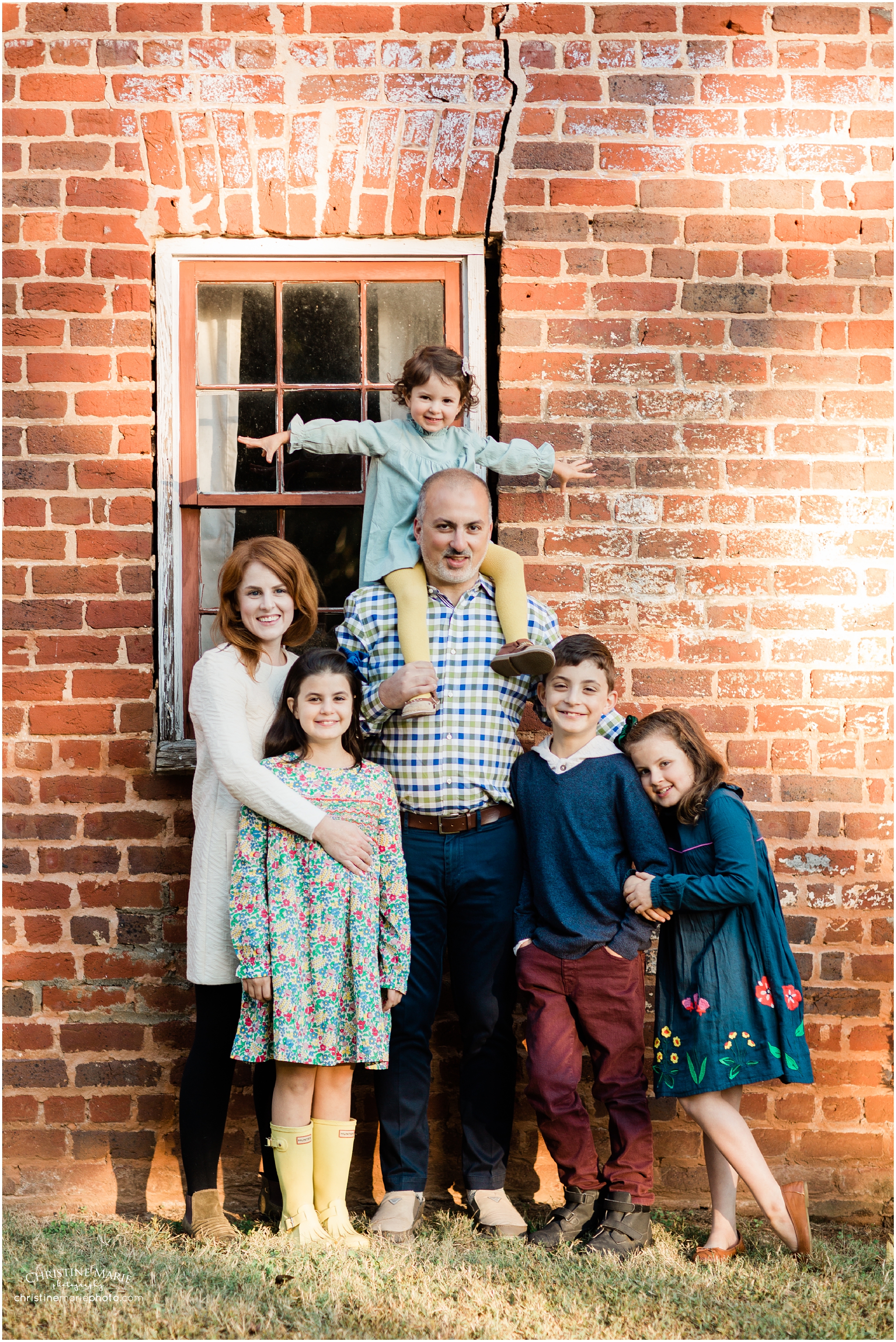 creative large family photo with brick wall, christine marie photography