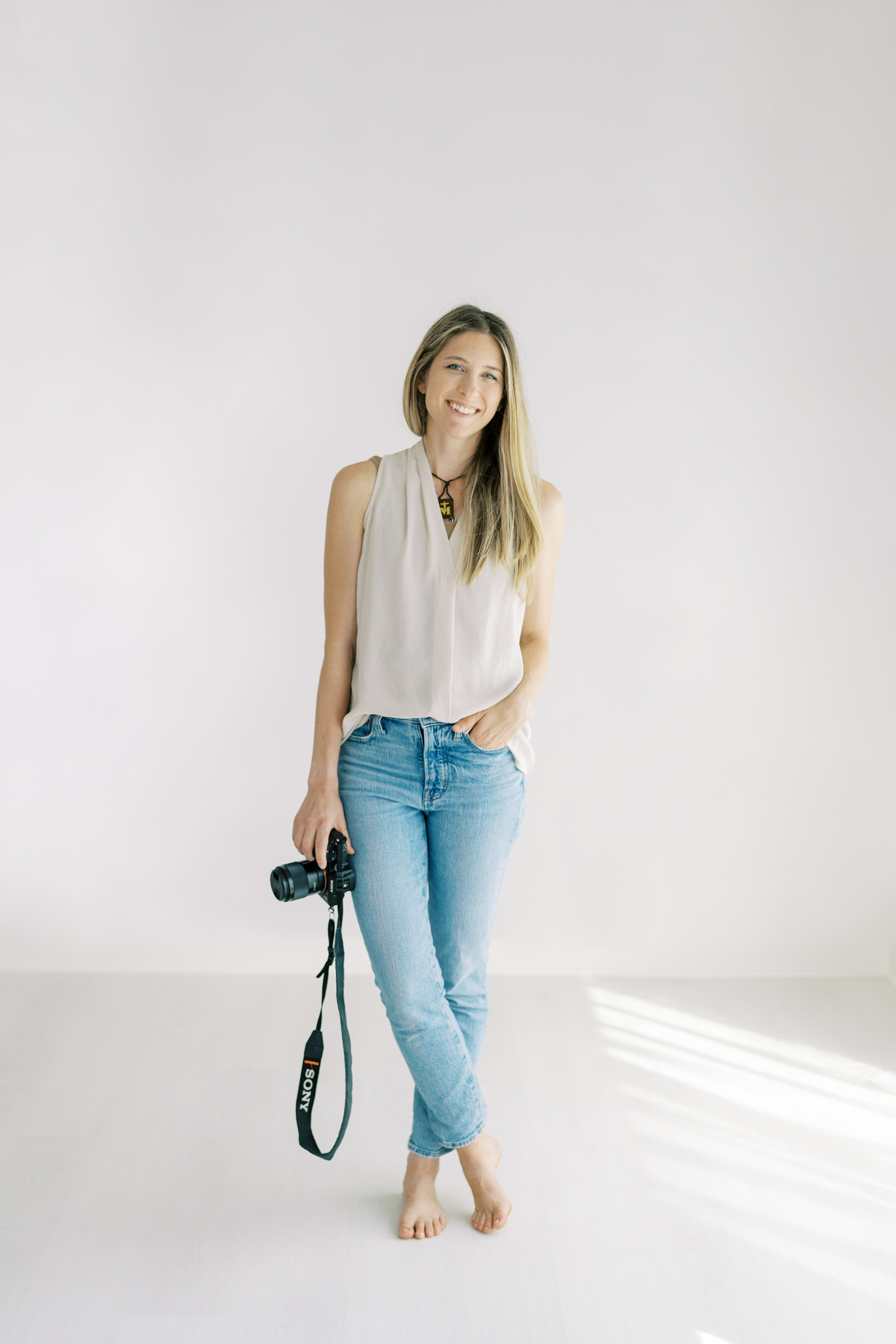 Cumming, GA photographer Christine Clements standing in her natural light studio.