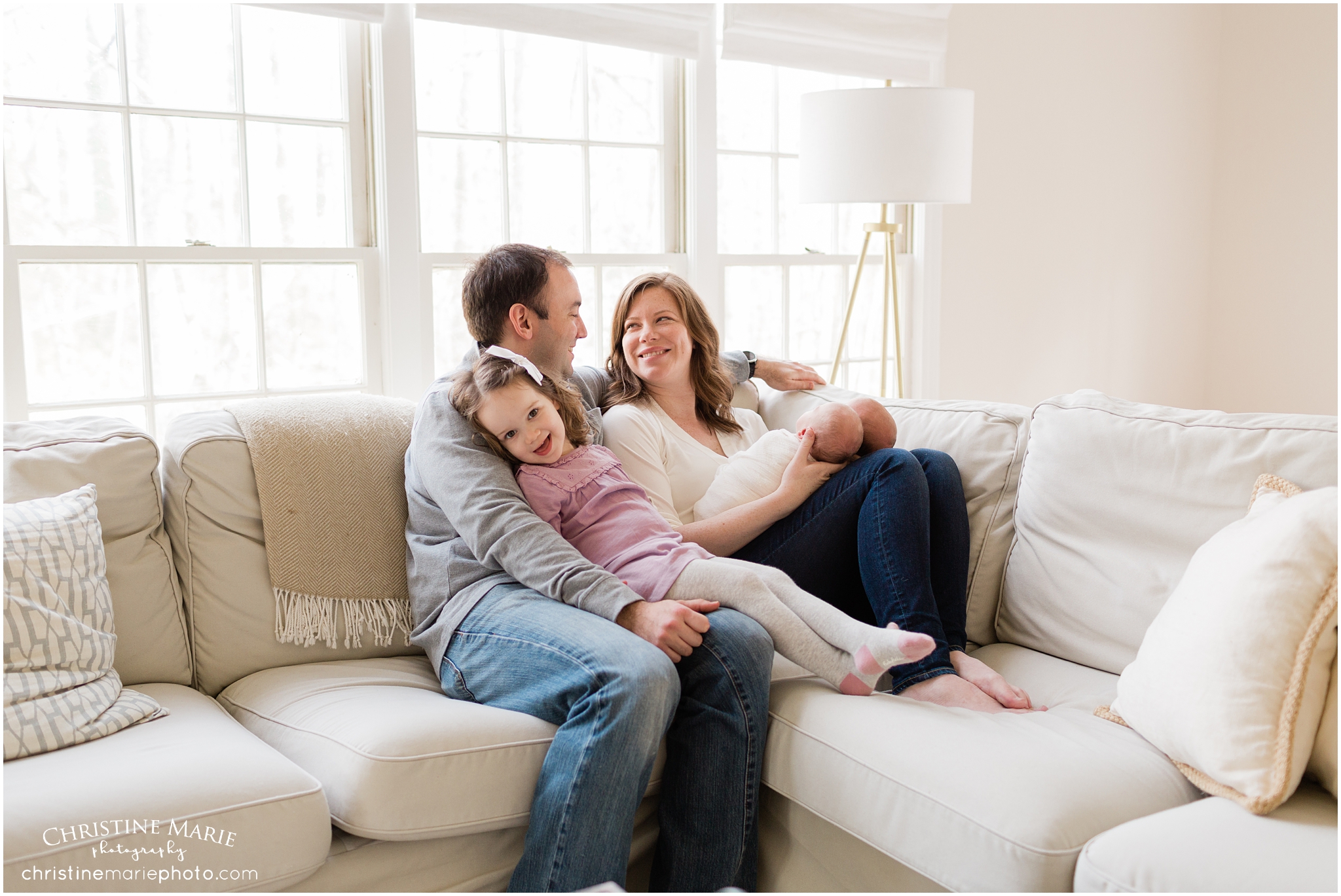 family snuggled on the couch