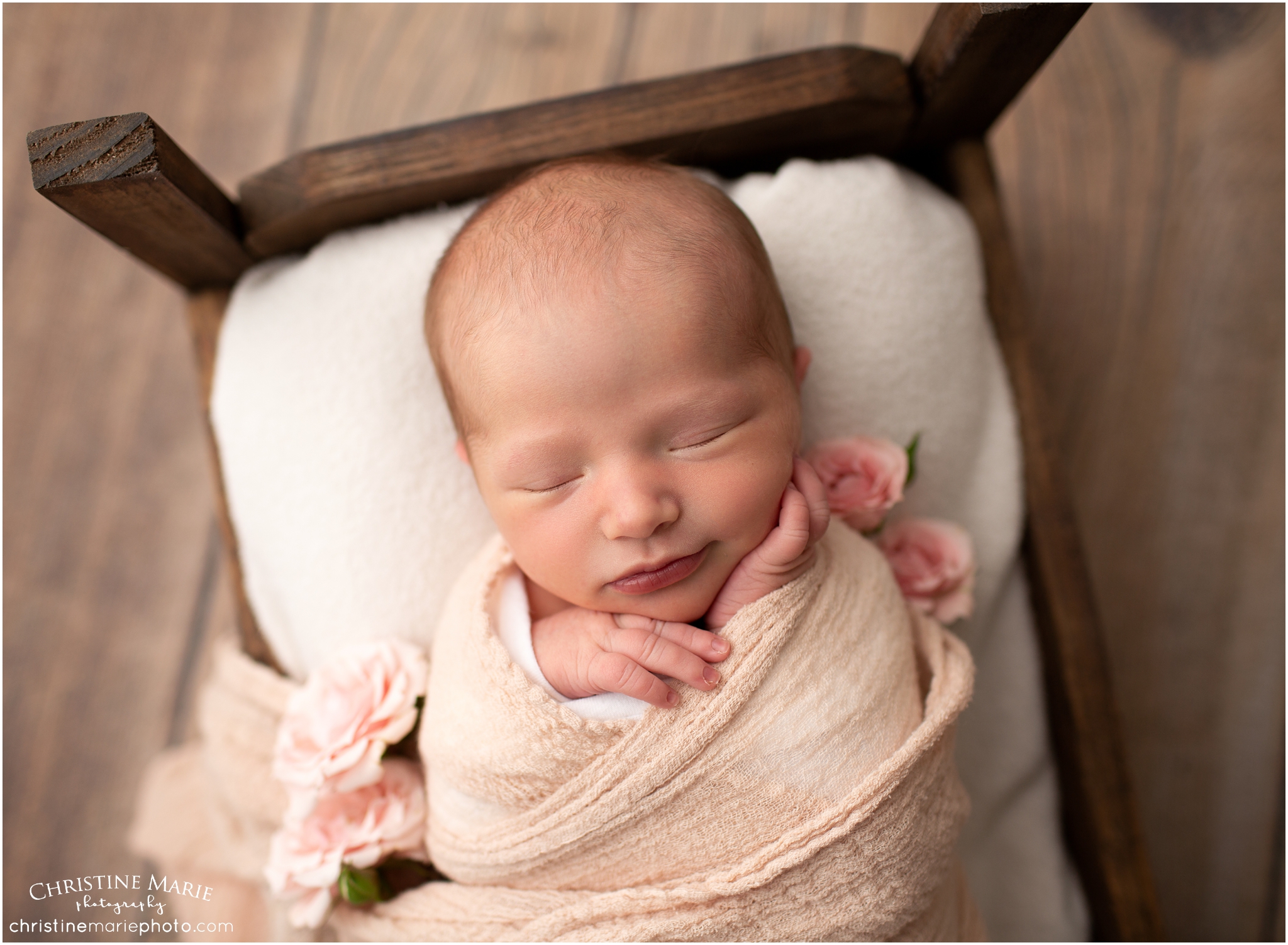 baby girl in wooden bed with flowers, christine marie photography
