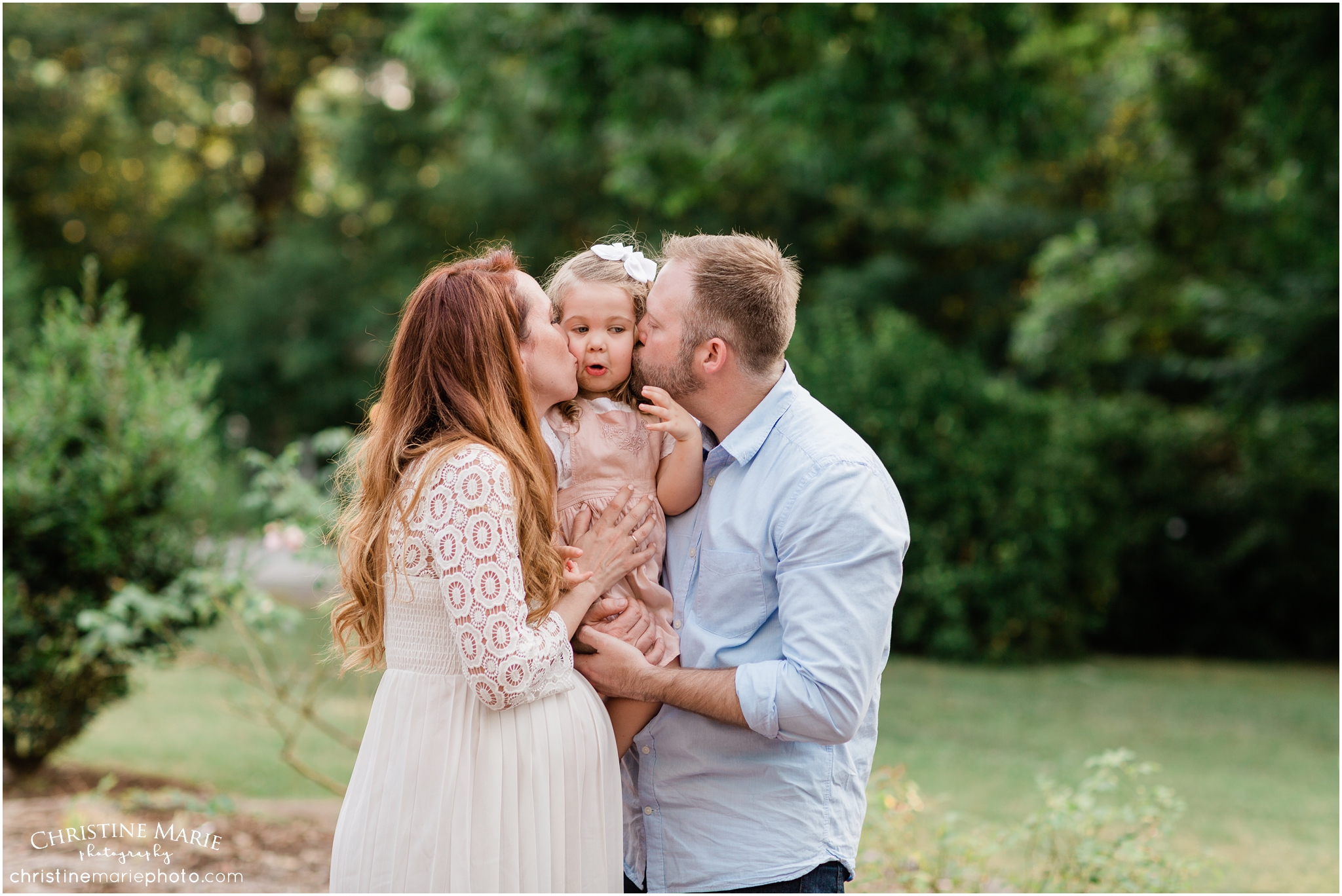 cute family kissing little girl