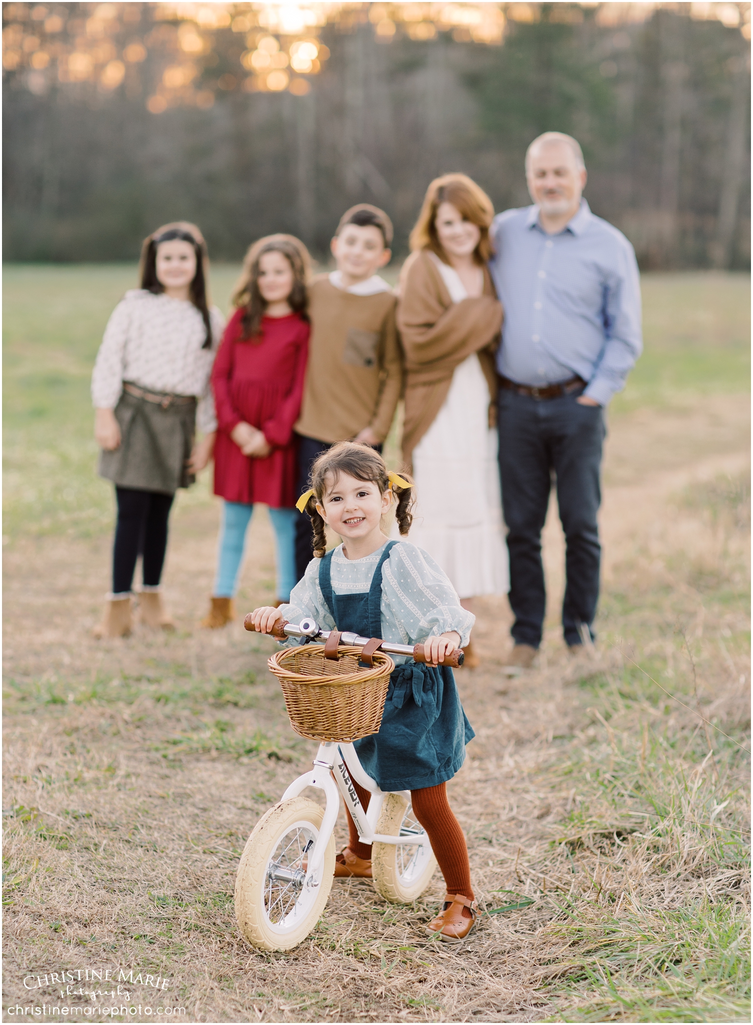 family photo with little girl on bike