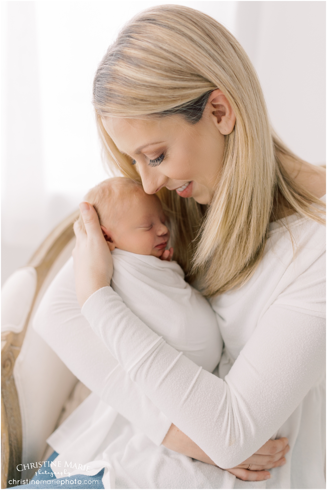 proud new mom holding little baby 