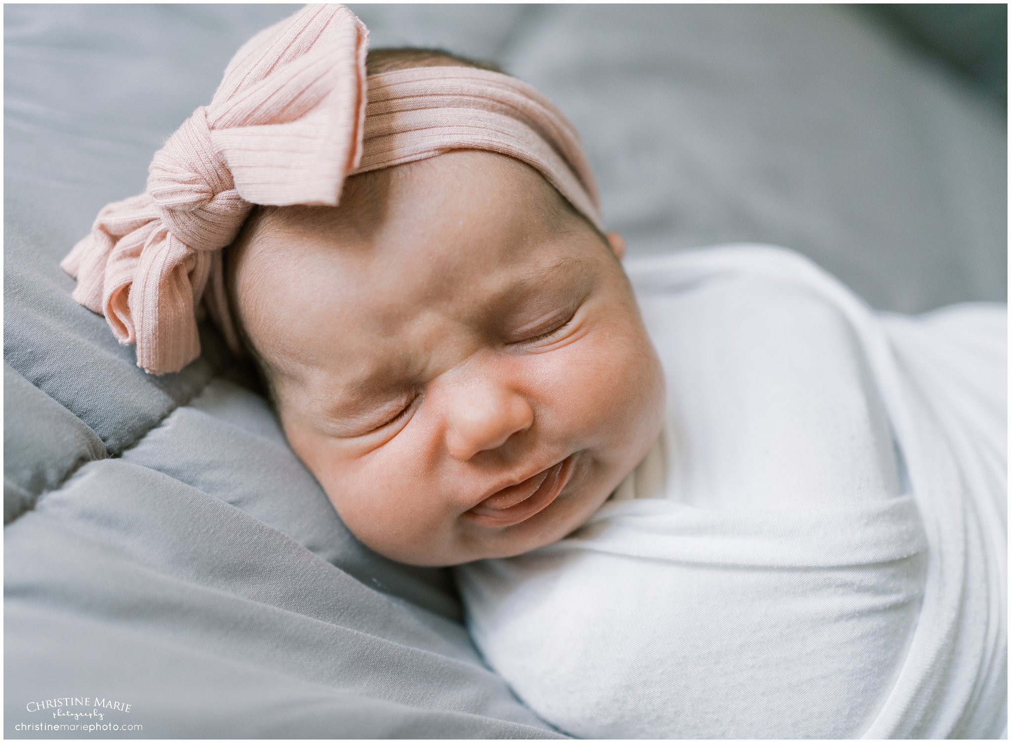 newborn baby girl making cute faec during newborn session