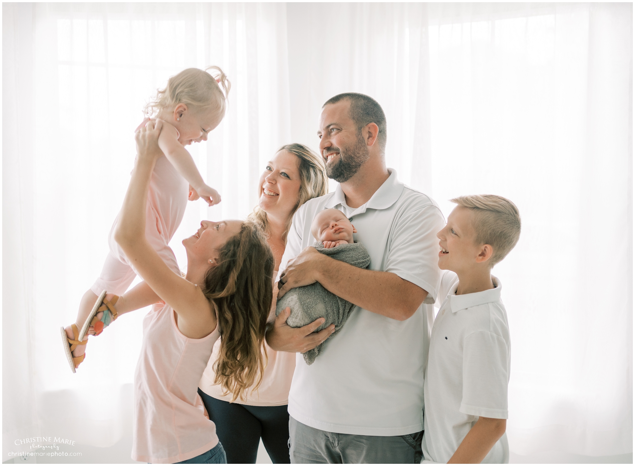 playful family and newborn photo in Cumming GA photography studio