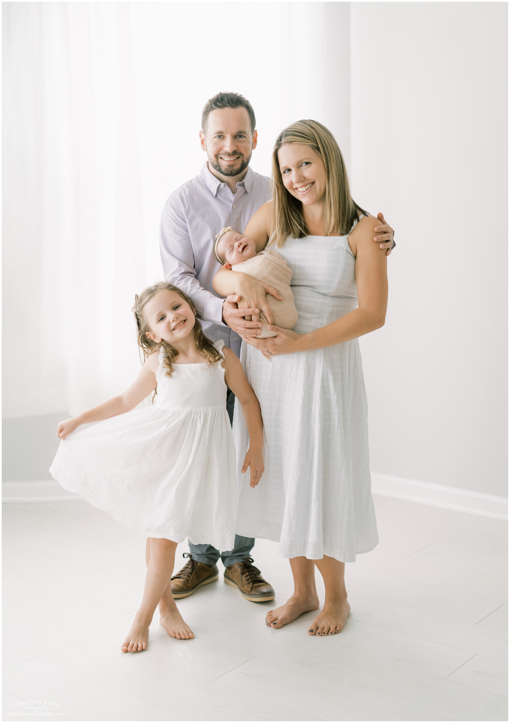 happy family in white studio by atlanta newborn photographer