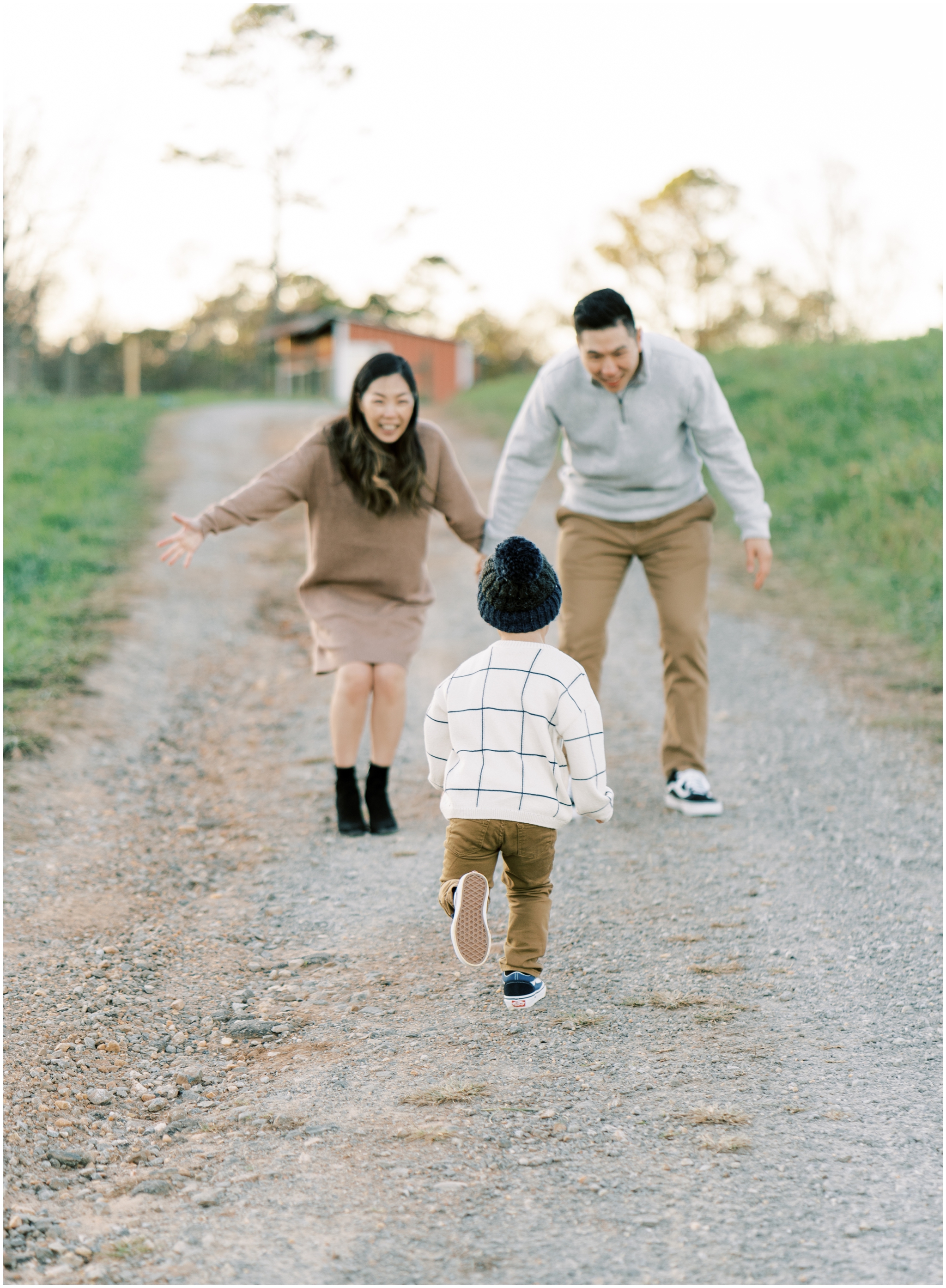 little boy running to hug parents during family photoshoot in cumming ga