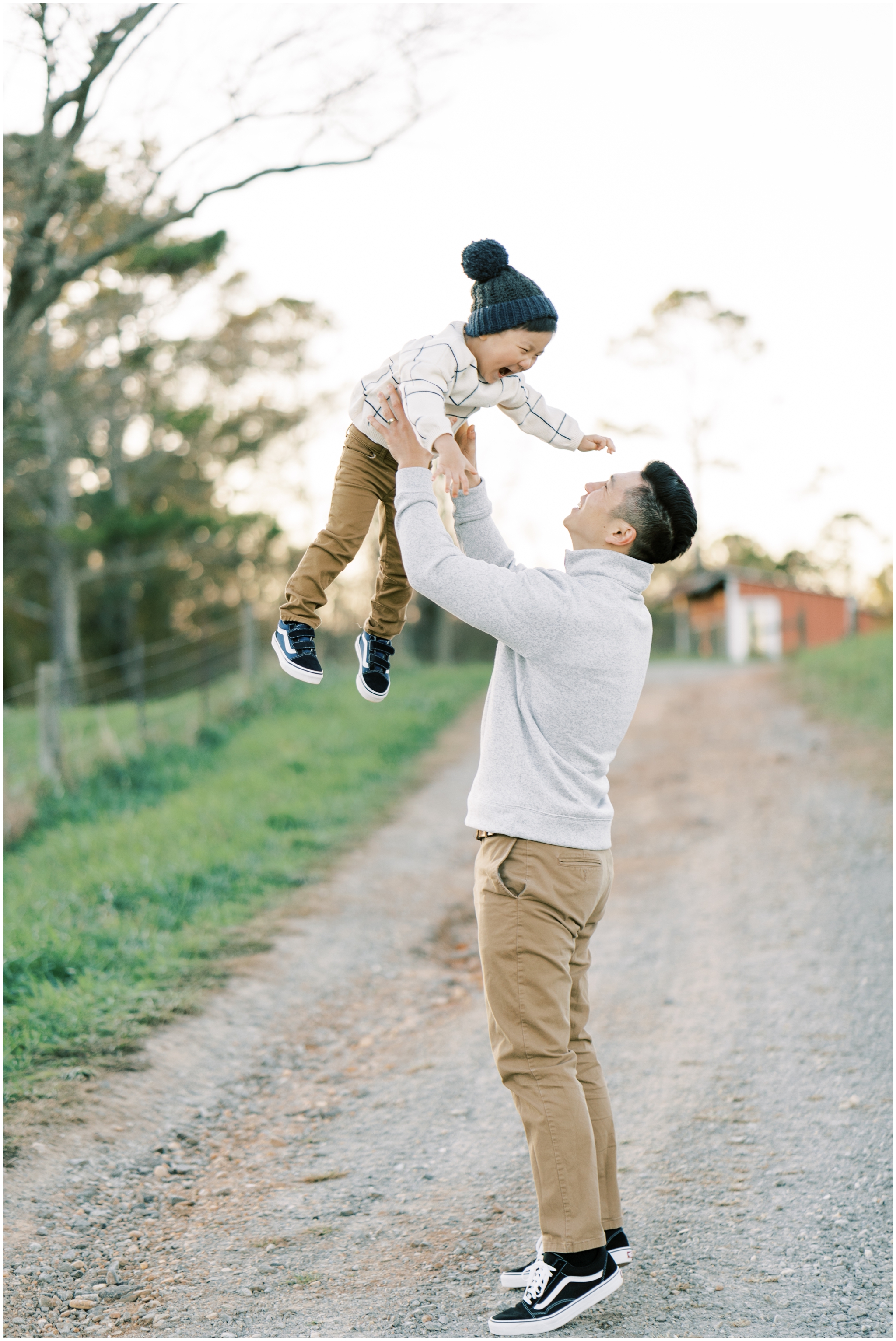 little boy playing with dad during family photoshoot in cumming ga