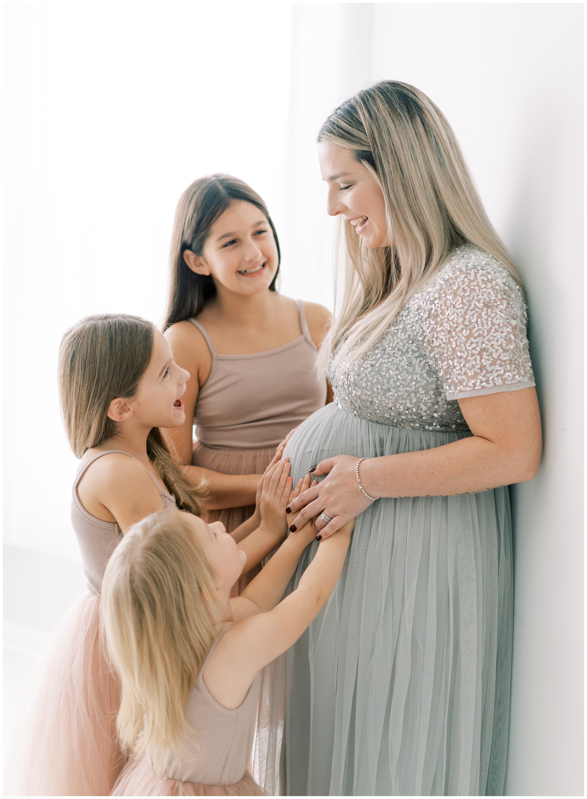 Light and airy studio maternity portraits with family