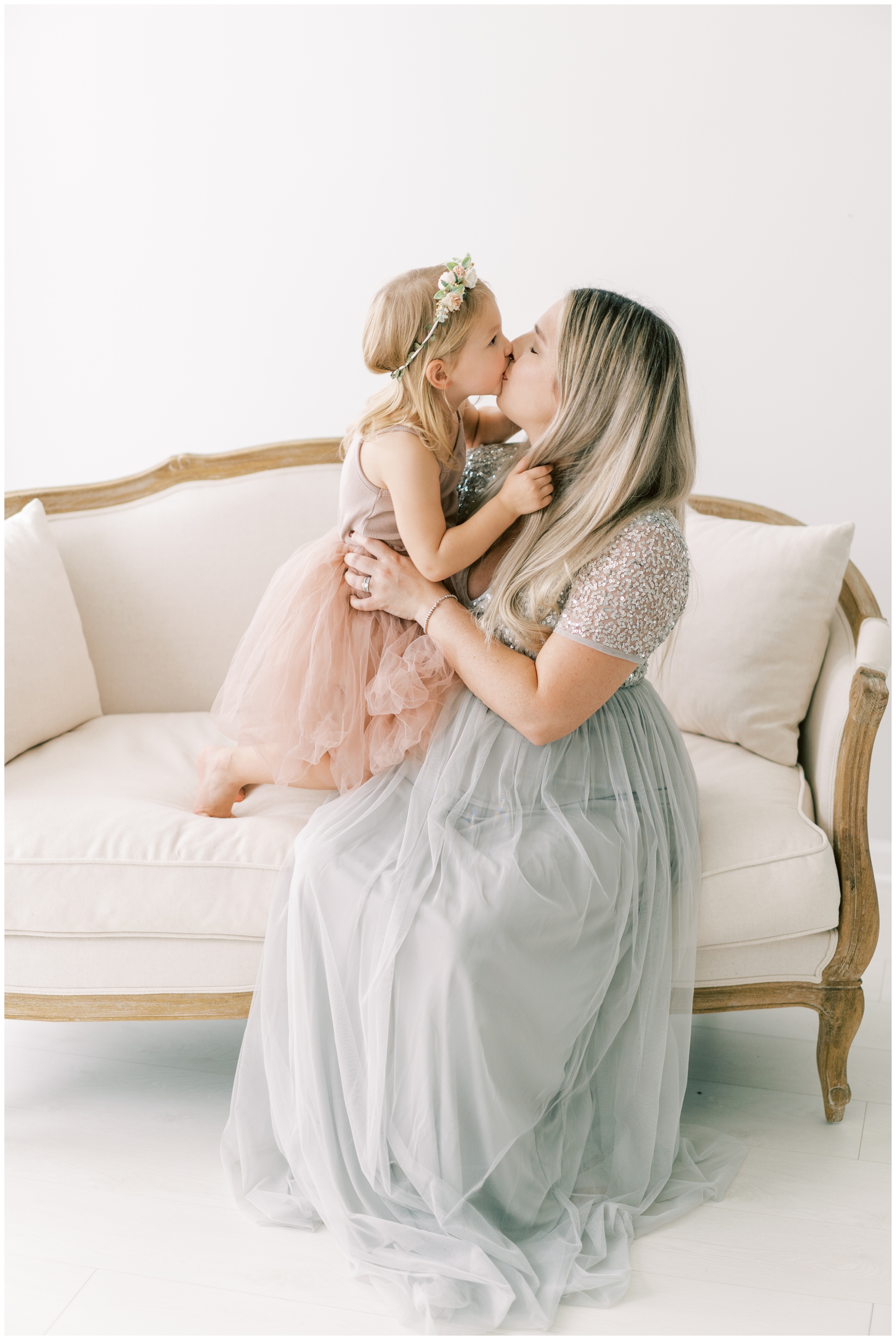 little girl in flower crown kissing pregnant mommy in gown, atlanta photographer