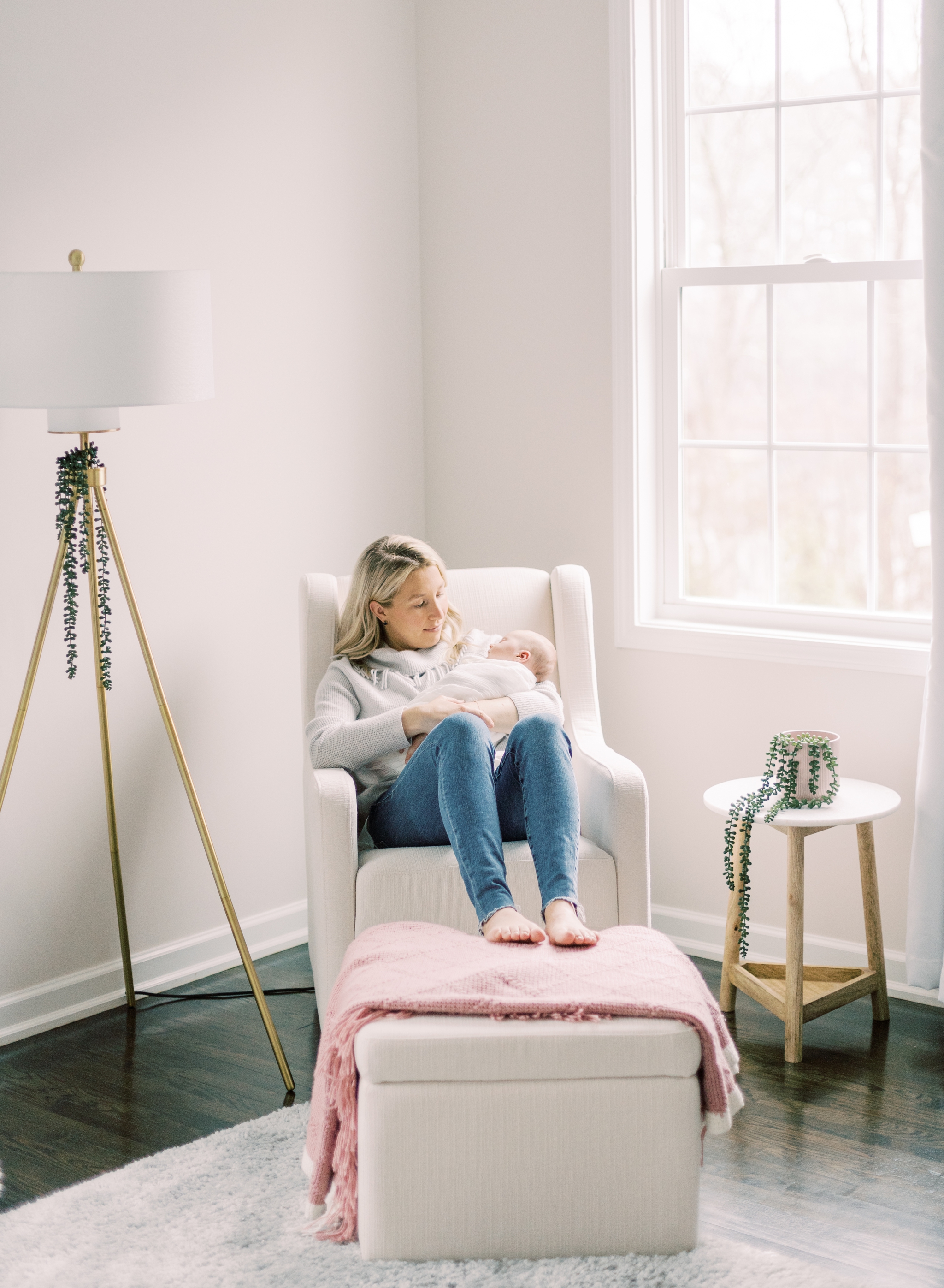 mother holding baby in nursery during lifestyle newborn session in Roswell, GA