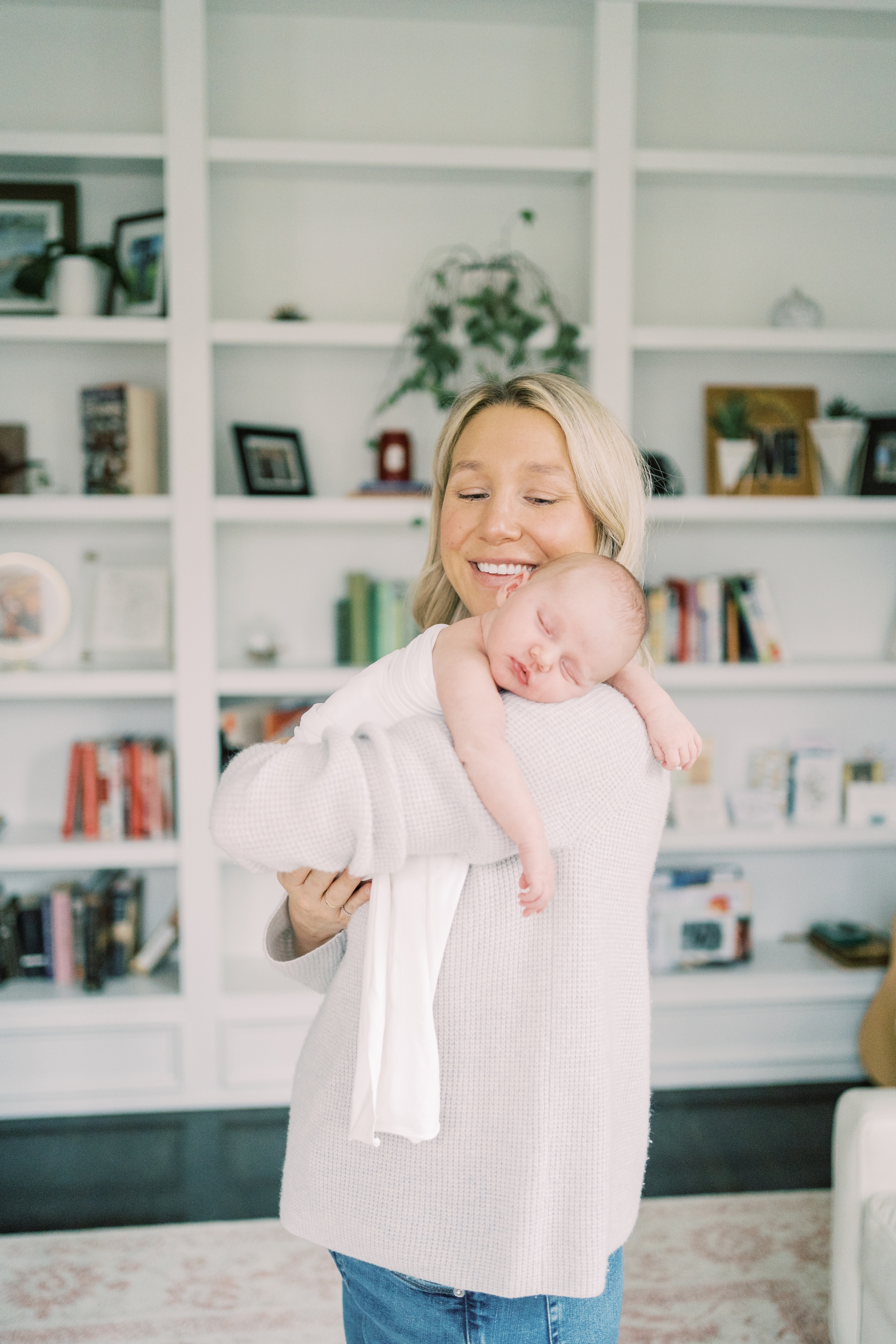 mom holding sleeping baby in Roswell, GA home