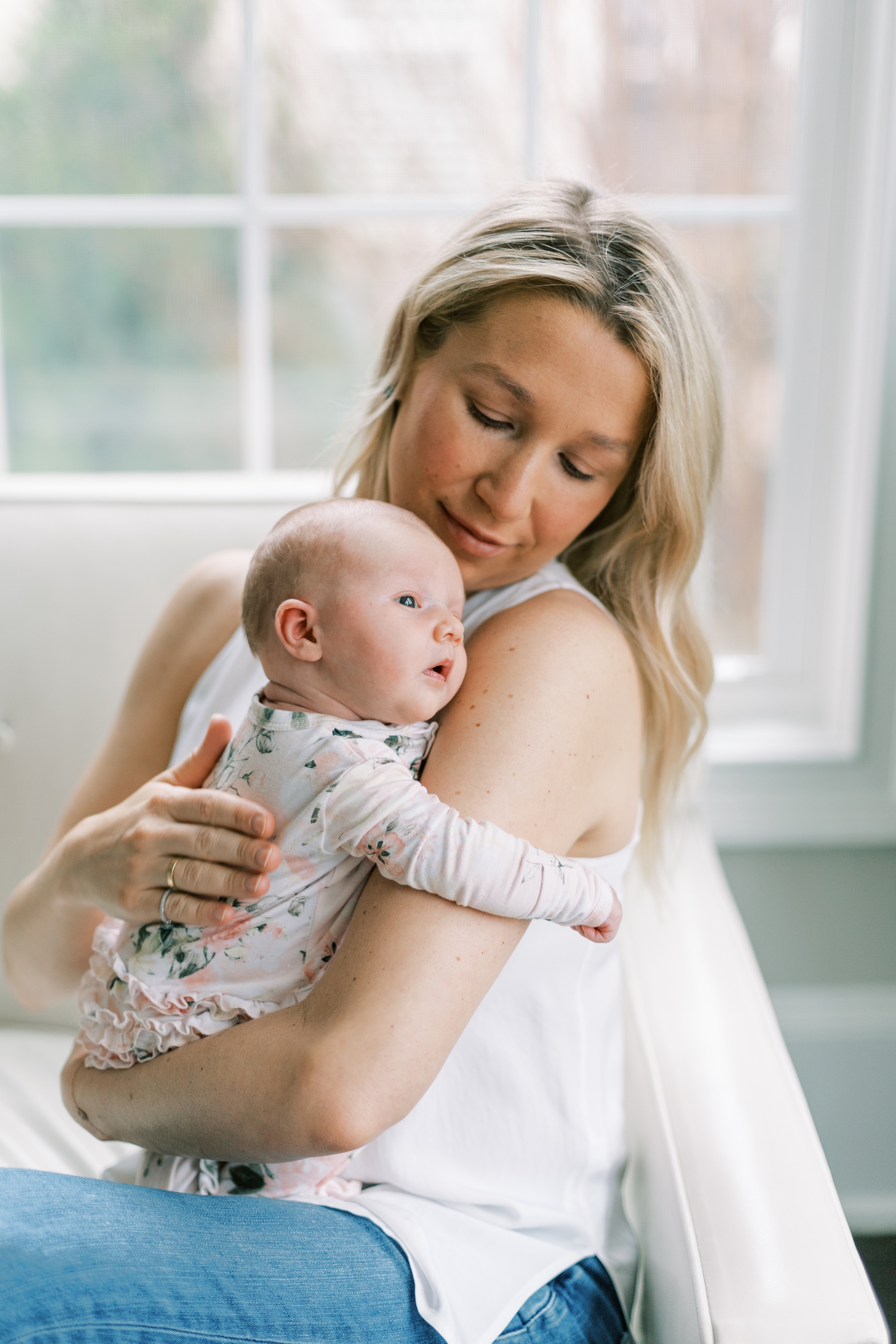 heartfelt and natural portrait of mother holding baby girl