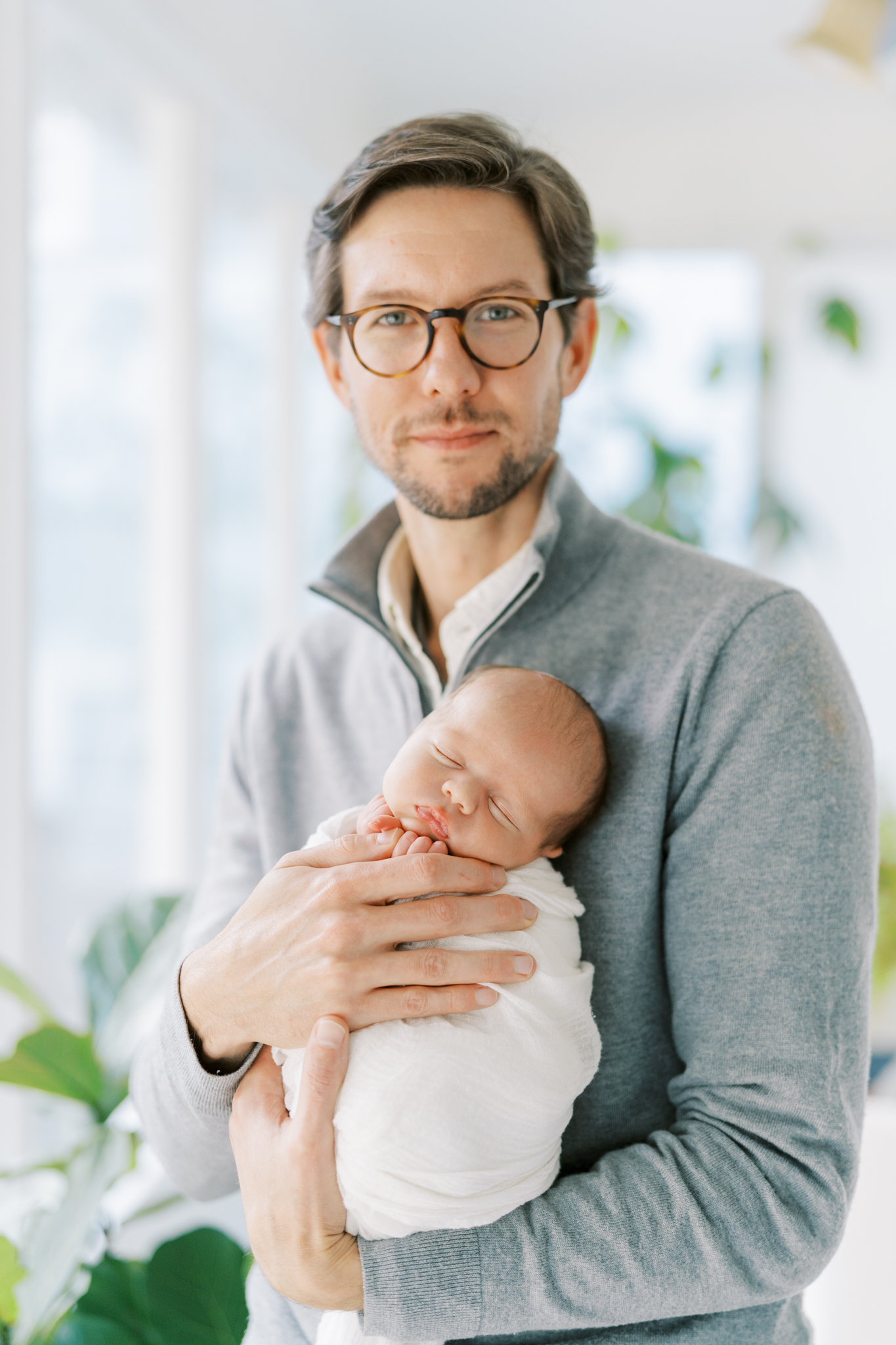 Stylish dad holding his newborn son for photoshoot in Atlanta. 