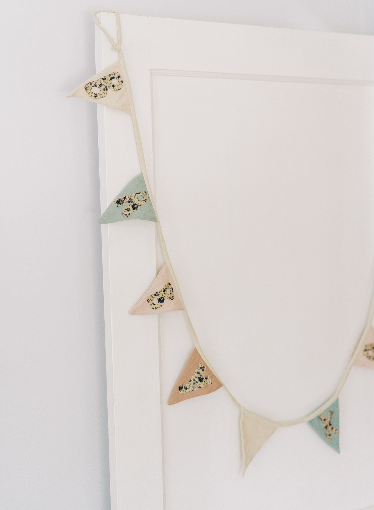 Name banner hanging off the door of a baby boy's nursery