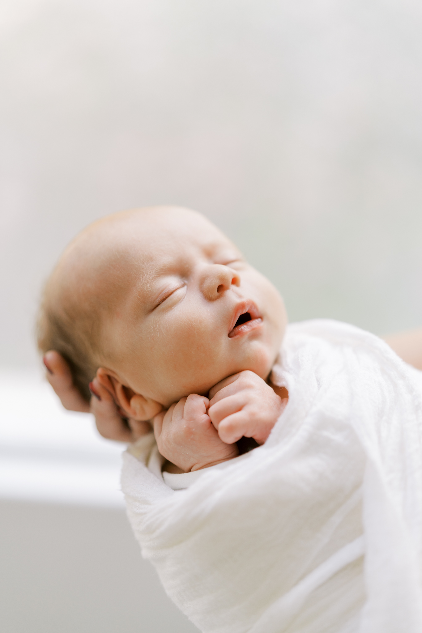 Detailed close up of a sleeping baby boy and his soft baby skin. 