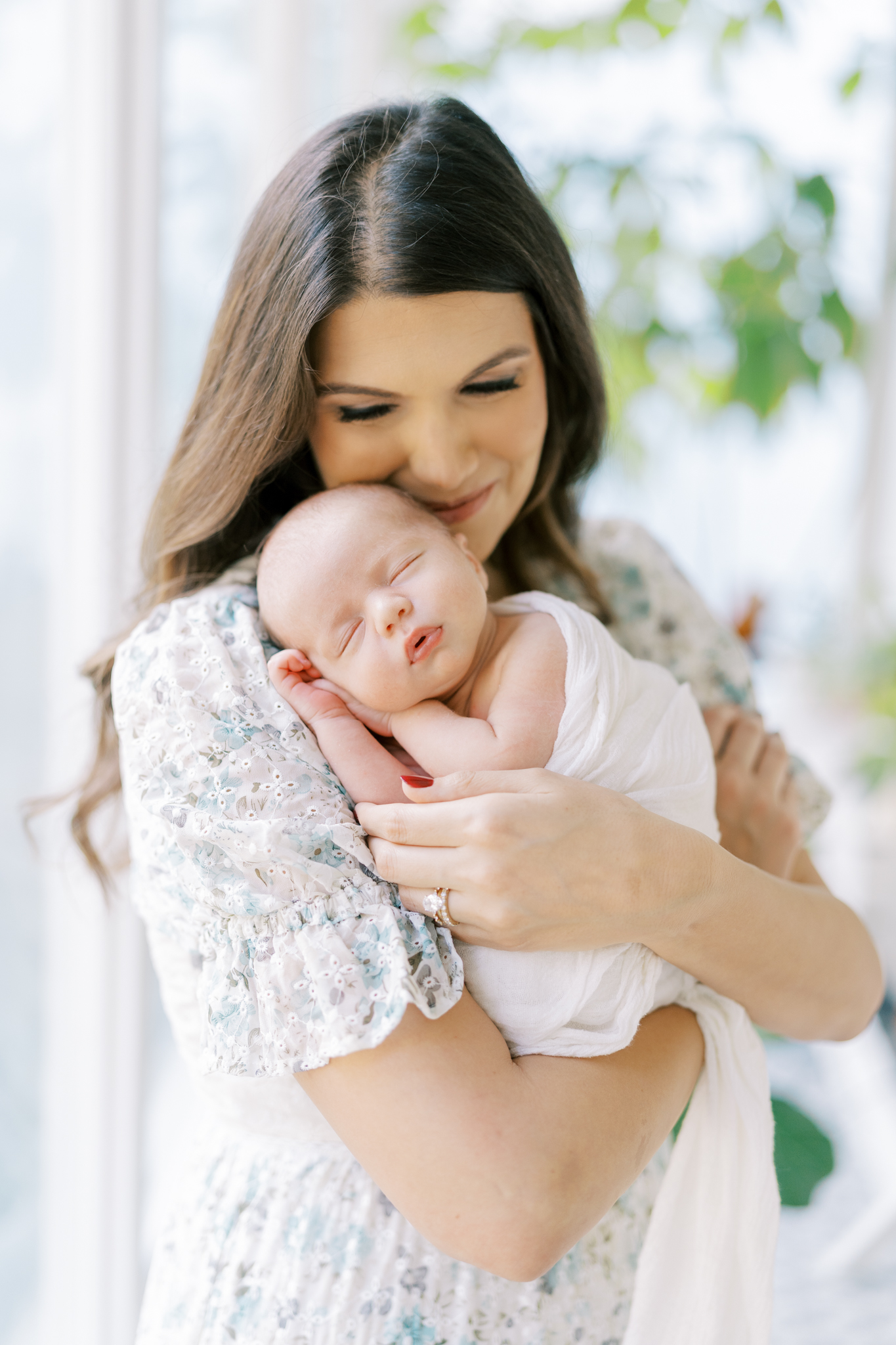 Stunning new mom snuggling her baby boy during photoshoot in Atlanta home. 
