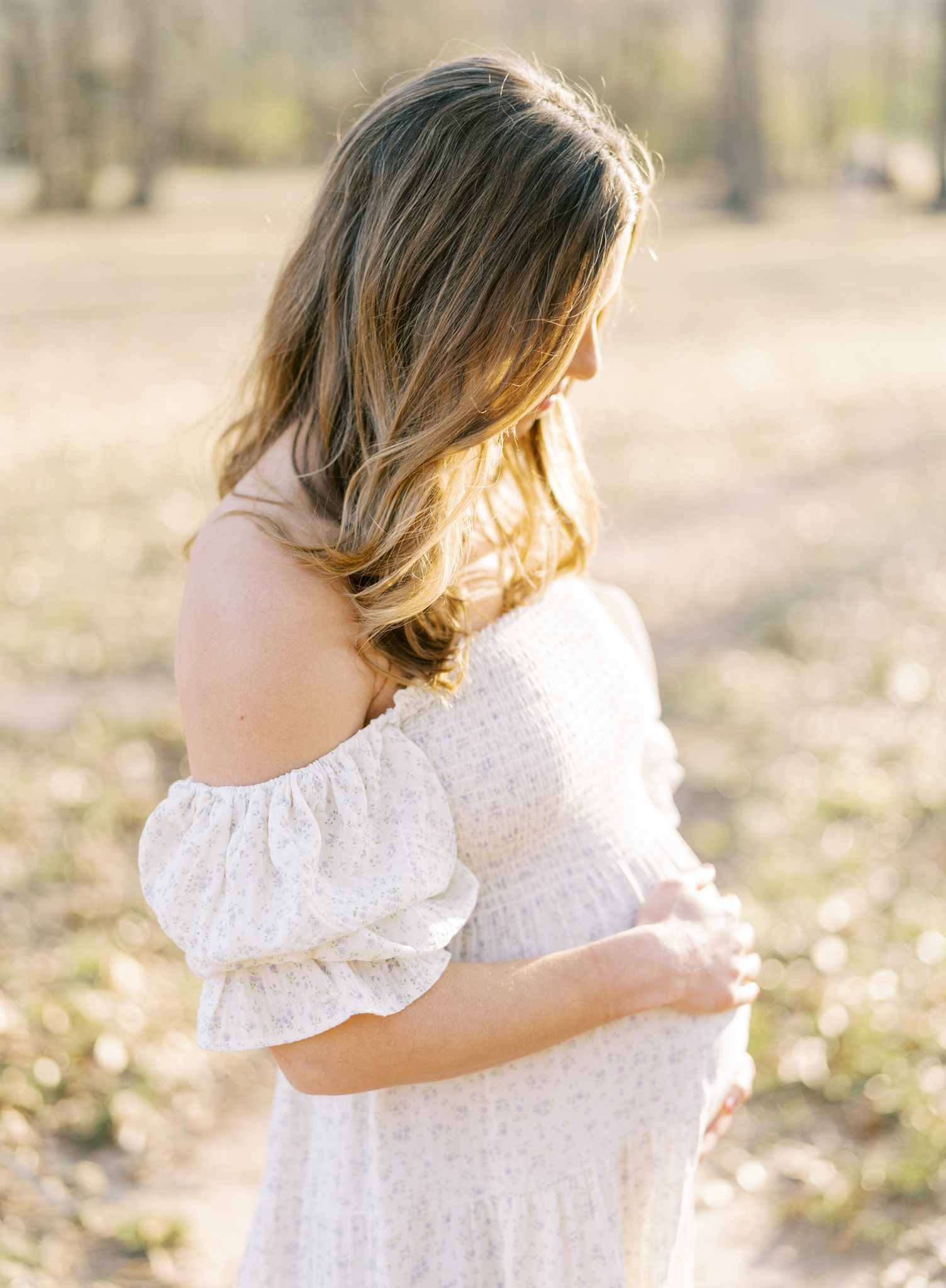 glowy winter light o pregnant woman looking off to the side